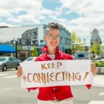 Ginger Johnson with sign, "Keep Connecting!"