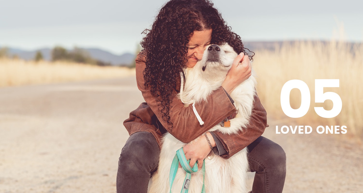 woman hugging her dog, old dirt road